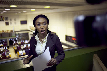 Nancy Illoh, a reporter on The Money Show, a program about finance and stocks on African Independent Television (AIT) broadcasts live from a balcony above the Nigerian Stock Exchange.