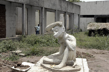 A woman in the ruins of the Bamboo Palace, one of the extravagant residences built by former President Mobutu Sese Seko in his native village in Equateur Province.