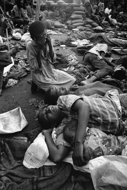 Survivors weep amongst the dead. Over 4,000 Hutus were killed on 22/04/1995 during an operation by the Tutsi Rwandan army to clear the Kibeho refugee camp. The tragedy occurred after the army opened f...