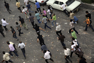Demonstrators run down Khosh Street. Following a disputed election result, thousands of supporters of opposition candidate Mir-Hossein Mousavi took to the streets in protest.