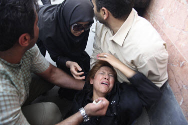 A woman injured after police fired tear gas on Khosh Street. Following a disputed election result, thousands of supporters of opposition candidate Mir-Hossein Mousavi took to the streets in protest.