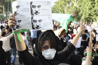 A young woman wearing a mask as a symbol of her silent protest. An estimated one million people formed a human chain along Vali asr Avenue, the longest street in Tehran. Following a disputed election...