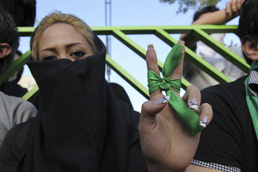 A young woman wearing green, the colour of the opposition. An estimated one million people formed a human chain along Vali asr Avenue, the longest street in Tehran. Following a disputed election resul...