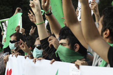 Protesters in Haftetir Square wearing green, the colour of the opposition, and masks as a symbol of their silent protest. Following a disputed election result, thousands of supporters of opposition ca...