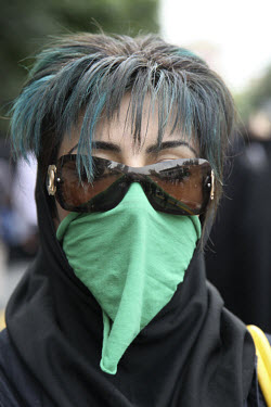 A young woman in Toopkhaneh Square with her hair dyed green, the colour of the opposition, and a green mask as a symbol of her silent protest. Following a disputed election result, thousands of suppor...