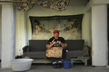 A woman knits in her home in El-Tyubyu village, in the republic of Kabardino-Balkaria in the North Caucasus.