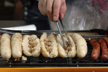 Vendor filling rice sausages with pork, a Taiwanese twist on the Hot Dog, at a food stall in the Feng Chia Night Market in Taichung. Night Markets are a bustling and lively cultural element in Taiwane...