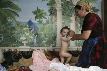 A woman finishes drying her young child at home in El-Tyubyu village, in the republic of Kabardino-Balkaria in the North Caucasus.