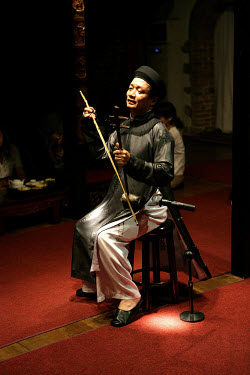 Musicians using traditional instruments at a performance in central Saigon.
