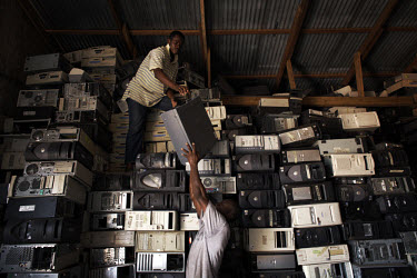 Computer hard drives are stacked high at an importer's warehouse in Accra. The majority of them are not working and will be scrapped. Containers arriving in Ghana with computers are often labelled sec...