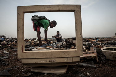 Children break apart CRT (cathode ray tube) monitors to salvage metal from inside at Agbogbloshie dump, which has become a dumping ground for computers and electronic waste from all over the developed...