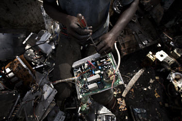 A man dismantles a circuit board to salvage components, at Agbogbloshie dump, which has become a dumping ground for computers and electronic waste from all over the developed world. Hundreds of tons o...