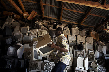 Computer monitors are piled high at an importer's warehouse in Accra. The majority of them are not working and will be scrapped. Containers arriving in Ghana with computers are often labelled second h...