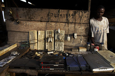 A man stands by this stall containing all sorts of salvaged electronics such as keboards, mice, scanners and hard drives at Agbogbloshie dump, which has become a dumping ground for computers and elect...