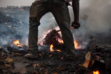 Burning cables from computers and other electronic equipment to retrieve copper, at Agbogbloshie dump, which has become a dumping ground for computers and electronic waste from all over the developed...