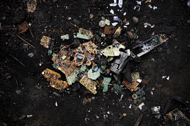 Broken pieces of circuit boards lie in the dirt at Agbogbloshie dump, which has become a dumping ground for computers and electronic waste from all over the developed world. Hundreds of tons of e-wast...