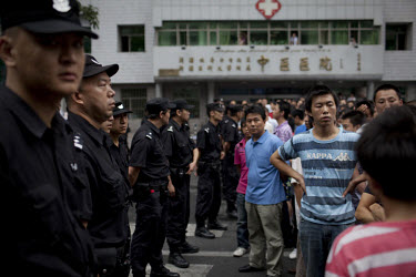A Han Chinese crowd confront riot police after they arrested two Han men who were part of a mob that chased down a Uighur in Urumqi. They caught up with the Uighur and beat him before the police inter...