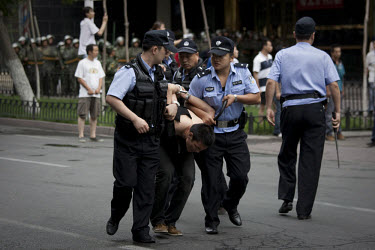 Police arrest a Han Chinese man who was part of a mob that chased down a Uighur in Urumqi. They caught up with the Uighur and beat him before the police intervened firing shots in the air and arrestin...