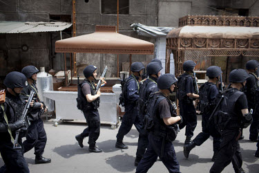 Anti-riot police conduct an operation in the Uighur district of Urumqi. Ethnic violence between the Uighur and Han Chinese people had erupted in the city a few days earlier.