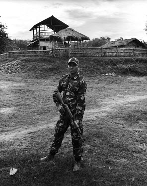 25 year old Lance Corporal Desring Dimasa (aka The Undertaker) poses for a portrait with an AK 56 assault rifle at the Basabari camp of the Dimasa militant group, Dima Halim Daogah (Jewel faction), al...
