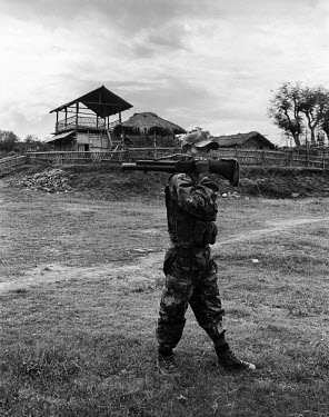 25 year old Lance Corporal Assampad Dimasa poses for a portrait with a Lethode bomb launcher at the Basabari camp of the Dimasa militant group, Dima Halim Daogah (Jewel faction), also known as Black W...