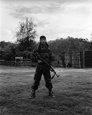 24 year old Corporal Jet Lee Dimasa (aka Kung fu Master) poses with an AK 56 assault rifle at the Basabari camp of the Dimasa militant group, Dima Halim Daogah (Jewel faction), also known as Black Wid...