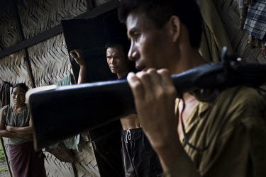 43 year old Damtuing (right), a Zeme Naga from Mabauram village, stands with his ancient hunting rifle. Like many Zeme Nagas, he has been forced to take shelter in the lower part of the village, after...