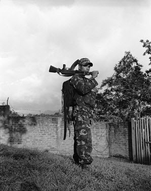 25 year old B Dimasa poses with an M16 assault rifle at the Dibari liaison office of the Dimasa militant group, Dima Halim Daogah (Jewel faction), also known as Black Widow, in Haflong. Recent ethnic...