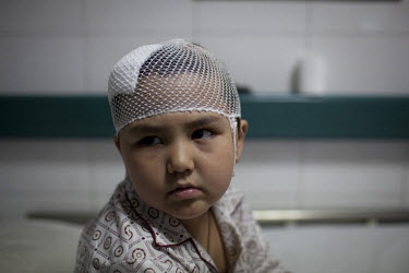 Aliya, a five year old Uighur girl who was beaten on the head when her and her pregnant mother were attacked by a Han Chinese mob on July 6th, recovers in Number 2 Hospital in Urumqi. Ethnic violence...