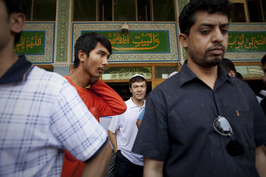 Uighur men leave the Yang Hang Mosque after Friday prayers in Urumqi. Due to the recent ethnic violence, Chinese authorities had tried to stop Friday prayers going ahead but at the last minute the doo...
