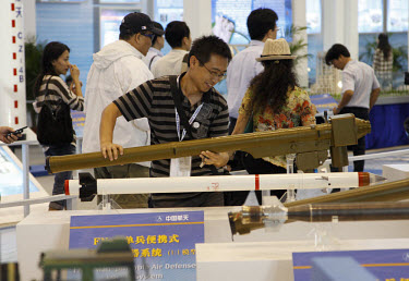 A worker carries a shoulder fired anti-aircraft missile at the 2008 China International Aerospace and Aviation Exhibition in Zhuhai.