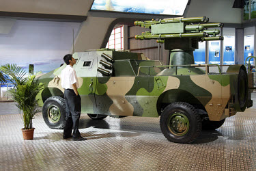 A visitor looks at anti-aircraft vehicles at the 2008 China International Aerospace and Aviation Exhibition in Zhuhai.