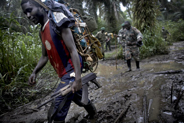 FDLR (Democratic Forces for the Liberation of Rwanda) soldiers trek to their jungle camp in North Kivu. The FDLR comprises Hutu extremists who fled Rwanda after their involvement in the 1994 genocide,...