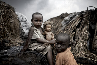 Displaced children sit outside their makeshift homes in the Mugunga I IDP camp, home to over 10,000 people.