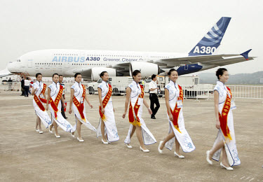 Ceremonial hostesses walks past a Airbus A380 jumbo jet at the 2008 China International Aerospace and Aviation Exhibition in Zhuhai.