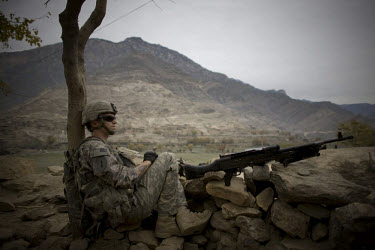 A US Army soldier from 3rd Platoon, Charlie Company, 1-26 Infantry on lookout during a meeting with village elders.