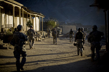 US Army soldiers from Charlie Company, 3rd Platoon patrol in Nanglam village in the Pech Valley in Kunar. The unit was providing security for a local English school graduation ceremony in an effort to...