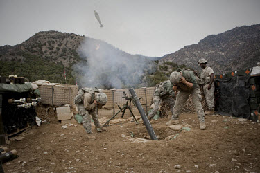 US Army Soldiers from Viper Company 126, 2nd Platoon, fire 120mm mortars in defense of an attack on Restrepo Firebase in the restive Korengal Valley. During the attack Sgt Lacie was shot in the head a...