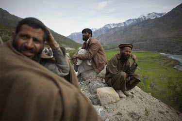 Villagers wait while US Forces investigate and recover a vehicle destroyed by a roadside bomb near Naray in Kunar. A unit of the 3rd Brigade Combat Team, 1st Infantry Division responded to an IED (imp...