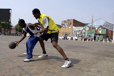 Young men play basketball on the Mary Fitzgerald Square in Newtown in central Johannesburg.
