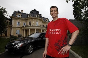Mikhail Prokhorov, Russia's richest man in 2009, poses in front of his Maybach car at his country residence outside Moscow. Prokorov made his fortune in investments. In 2009 his estimated net worth wa...