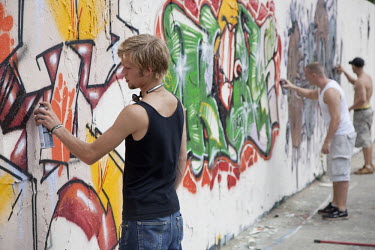 Graffiti artists at work in the Mauerpark (Berlin Wall Park).