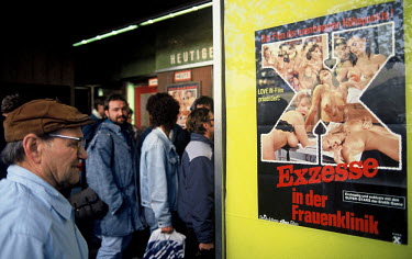 East Germans line up outside a cinema in West Berlin to get their first glimpse of Western pornography in the days after the opening of the Berlin Wall.