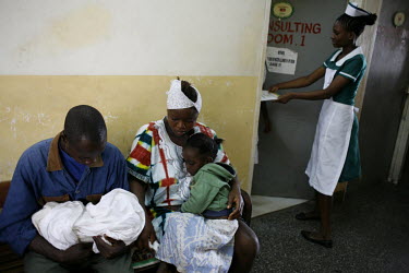 Sudanese refugees Samuel Gizaza Sala (24), his wife Menshi Sala (17) and their daughter Jackie (3) wait for a doctor to see their three day old son Simon. Samuel and his family fled to Accra from Darf...