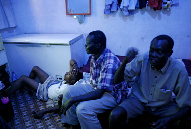 Sudanese refugees Santino William Lado (45, centre) and Lawerence Kenyi Yata (40, right) watch the 2010 World Cup qualifying football match between Ghana and Sudan with fellow refugee Christian Cass (...