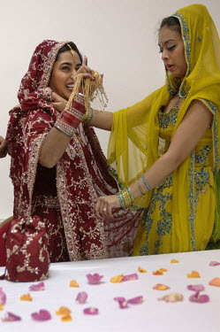 Young British Indian woman getting ready for her Sikh wedding at a Sikh Temple (Gurdwara) in Leicester.
