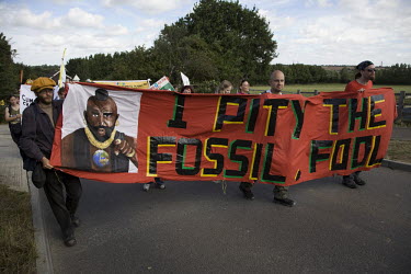 Protesters carry a banner featuring actor Mr T (B.A. Baracus) and a fossil fuels related play on his catchphrase "I pity the fool". Climate Camp, an environmental group opposing government policies th...