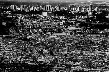 Kibera slum, with the high-rise buildings of the city centre behind. Over 25 percent of Nairobi's population live in Kibera, an area that covers less than one percent of the city. Although the populat...