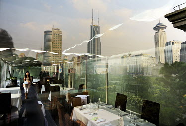 City centre skyscrapers reflected in the window of an expensive restaurant on the top floor of the former club house of the colonial-era race course.