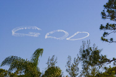 An airplane has written the word ^GOD^ in the sky above Lake Worth, Florida.